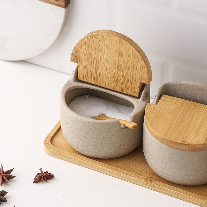 https://dilashome.com/cdn/shop/products/serene-porcelain-spice-jar-sugar-salt-condiment-pot-container-with-bamboo-lid-wooden-spoon-tray-3@2x.jpg?v=1633676170